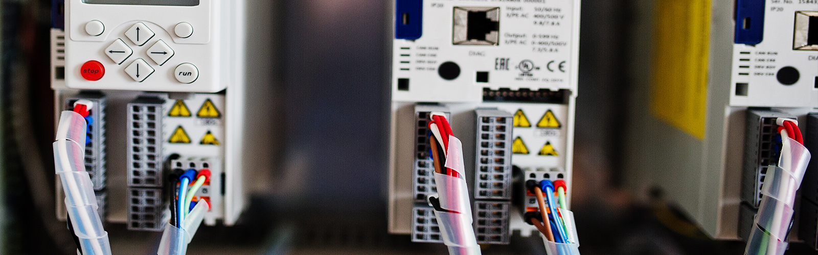 Man, an electrical technician working in a switchboard with fuses.